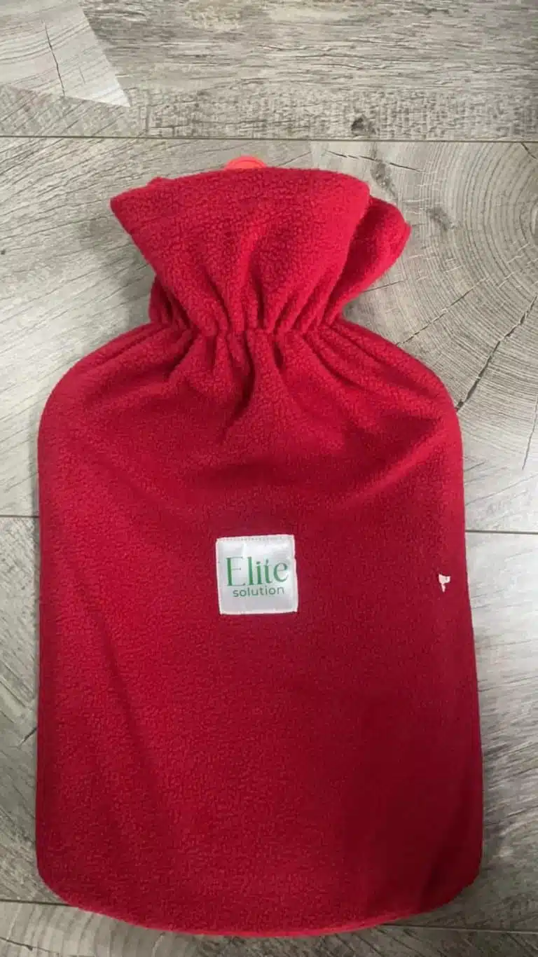 A red flannel thermal container designed for heat therapy and warming, made by Elite Solution. The Elite hot water bottle. Elite Hot Water Bag